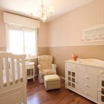 Pink nursery with white furniture