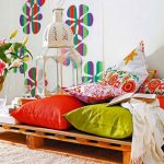 Multi-colored pillows on pallets in the room