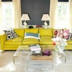 Transparent table and yellow sofa in the interior