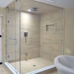 Shower cubicle with sand tiles and white door