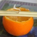 Mettez la mèche au centre de la mandarine