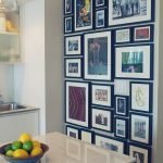 Many photo frames on the wall in the kitchen