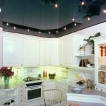 The combination of white furniture and black ceiling