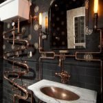 Bronze pipes on a black wall background