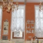 The combination of white curtains and orange walls