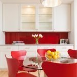 Cadeiras vermelhas em torno de uma mesa de vidro