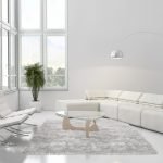 Obývací pokoj v bílé barvě s velkým rohovým oknem