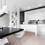 The combination of white and black in the design of the kitchen