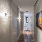 Couloir avec des peintures et des lumières sur le mur
