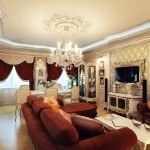 Gold tones in the design of the living room in a classic style