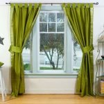 Green curtains on the window in the room