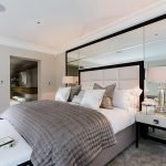 Mirrors in the design of the bedroom with a large bed