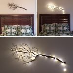 Illuminated branch on the wall